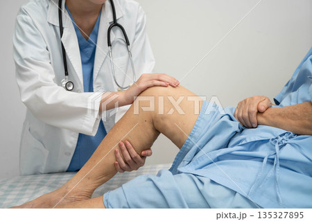 Doctor checking Asian elderly woman patient with scar knee replacement surgery in hospital. Doctor checking Asian elderly woman patient with scar knee replacement surgery in hospital. 135327895