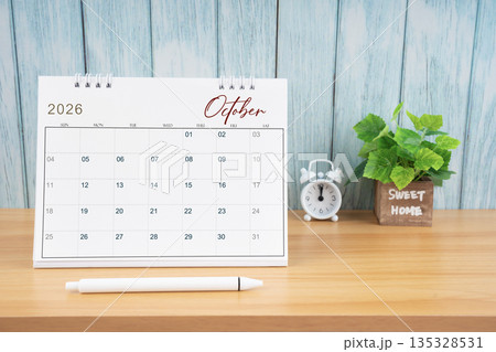 October Monthly desk calendar for 2026 year and alarm clock. October Monthly desk calendar for 2026 year and alarm clock. 135328531
