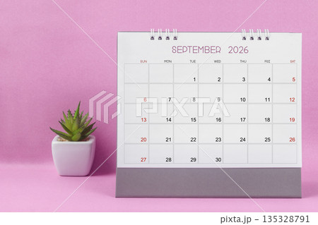 September 2026 desk calendar for year 2026 on pink background. 135328791
