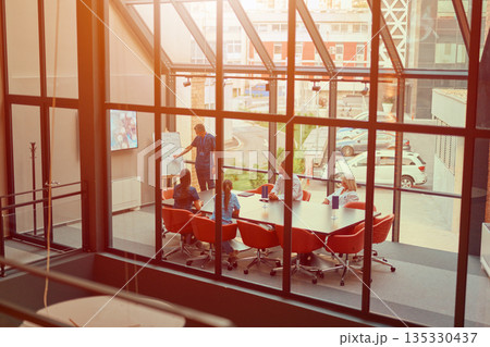Team collaborates in a modern conference room during a productive business meeting in an urban setting 135330437