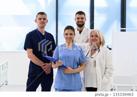Healthcare team poses together in a bright hospital environment, showcasing unity and professionalism among staff members Healthcare team poses together in a bright hospital environment, showcasing unity and professionalism among staff members 135330463