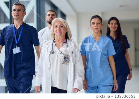 Healthcare professionals walking through a hospital corridor during a busy shift 135330555