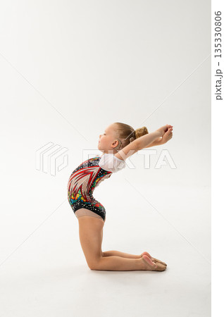 Young gymnast with a cochlear implant performs a graceful backbend in a studio. Inclusive sport, hearing technology, rehabilitation, and artistic movement through rhythmic gymnastics and ballroom Young gymnast with a cochlear implant performs a graceful backbend in a studio. Inclusive sport, hearing technology, rehabilitation, and artistic movement through rhythmic gymnastics and ballroom 135330806