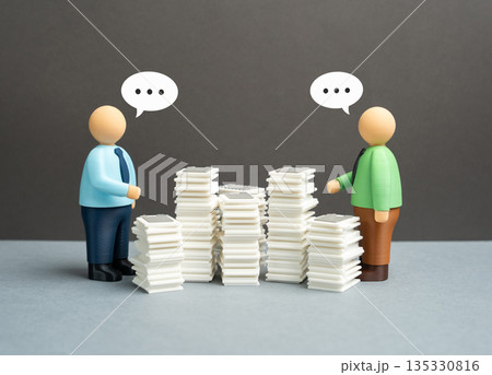 Two office workers are having difficulty communicating due to formalities and bureaucracy. Excessive rules, slow processes and barriers to collaboration harming teamwork and decision making Two office workers are having difficulty communicating due to formalities and bureaucracy. Excessive rules, slow processes and barriers to collaboration harming teamwork and decision making 135330816