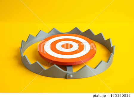 A round target in the center of a trap. Conceptualizing the danger of falling into a trap and failing. Strategic risk symbol, false goals and pressure decisions. Awareness of threats 135330835