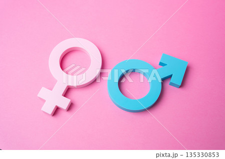 Male and female gender symbols on a pink background. Heterosexual relationships. Valentine's Day. Romantic connection concept, love symbolism and celebration of partnership Male and female gender symbols on a pink background. Heterosexual relationships. Valentine's Day. Romantic connection concept, love symbolism and celebration of partnership 135330853