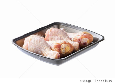 raw chicken legs or chicken drumsticks in a plastic container isolated on a white background. raw chicken legs or chicken drumsticks in a plastic container isolated on a white background. 135331039