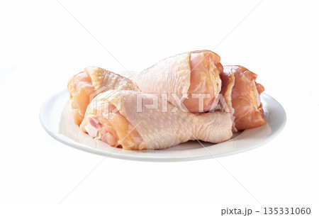 raw chicken legs or chicken drumsticks on a plate isolated on a white background. raw chicken legs or chicken drumsticks on a plate isolated on a white background. 135331060