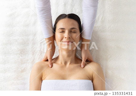 Young beautiful woman relaxing during professional spa shoulder massage, top view 135331431
