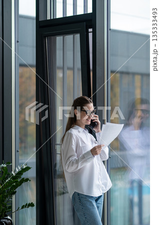 Young female manager working in the office and looking busy Young female manager working in the office and looking busy 135333493