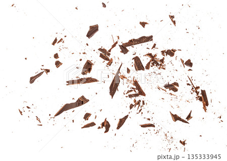 Scattered dark chocolate shards isolated on white background with dynamic flat lay and copy space 135333945
