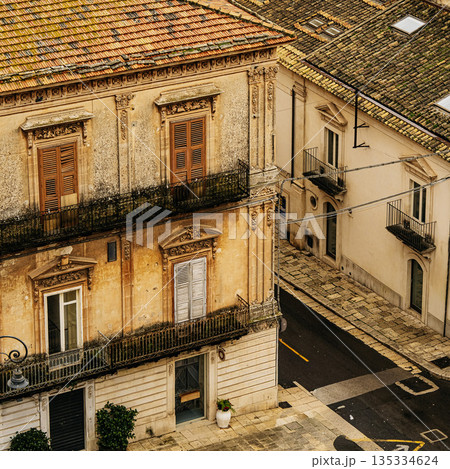 Historic Urban Architecture In Ragusa, Sicily: Weathered Stone Buildings, Narrow Streets, Layered Rooftops, And Church Dome Forming Dense Mediterranean Cityscape Historic Urban Architecture In Ragusa, Sicily: Weathered Stone Buildings, Narrow Streets, Layered Rooftops, And Church Dome Forming Dense Mediterranean Cityscape 135334624