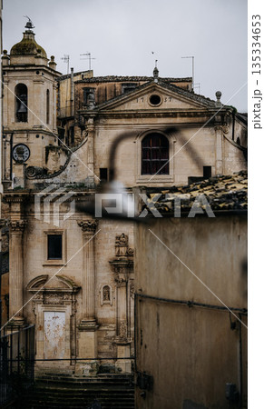 Church Of Santa Maria Dell Itria In Ragusa, Sicily: Historic Baroque Stone Facade And Bell Tower Rising Above Traditional Southern Italian Old Town Church Of Santa Maria Dell Itria In Ragusa, Sicily: Historic Baroque Stone Facade And Bell Tower Rising Above Traditional Southern Italian Old Town 135334653