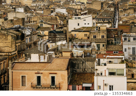 Panoramic View Over Ragusa From Cathedral Of San Giovanni Battista: Historic Sicilian City Rooftops, Church Domes, And Dense Stone Architecture Under Overcast Sky Panoramic View Over Ragusa From Cathedral Of San Giovanni Battista: Historic Sicilian City Rooftops, Church Domes, And Dense Stone Architecture Under Overcast Sky 135334663