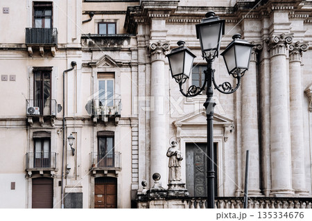 Church Of San Camillo Ai Crociferi In Catania, Sicily: Historic Baroque Church Facade With Twin Bell Towers And Stone Architecture Under Cloudy Sky Church Of San Camillo Ai Crociferi In Catania, Sicily: Historic Baroque Church Facade With Twin Bell Towers And Stone Architecture Under Cloudy Sky 135334676