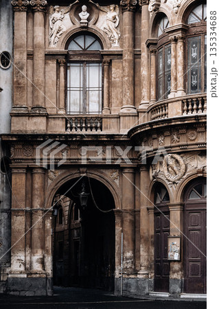 Historic Stone Archway In Italian City: Ornate Facade With Arched Passage, Decorative Windows, And Weathered Classical Architecture Historic Stone Archway In Italian City: Ornate Facade With Arched Passage, Decorative Windows, And Weathered Classical Architecture 135334688