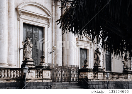 Church Of San Camillo Ai Crociferi In Catania, Sicily: Historic Baroque Church Facade With Twin Bell Towers And Stone Architecture Under Cloudy Sky Church Of San Camillo Ai Crociferi In Catania, Sicily: Historic Baroque Church Facade With Twin Bell Towers And Stone Architecture Under Cloudy Sky 135334696