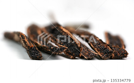 Vanilla pods cut with knife, black seeds visible, closeup macro detail photo isolated on white background Vanilla pods cut with knife, black seeds visible, closeup macro detail photo isolated on white background 135334779