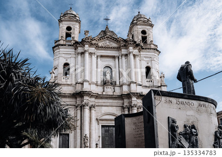 Church Of San Camillo Ai Crociferi In Catania, Sicily: Historic Baroque Church Facade With Twin Bell Towers And Stone Architecture Under Cloudy Sky Church Of San Camillo Ai Crociferi In Catania, Sicily: Historic Baroque Church Facade With Twin Bell Towers And Stone Architecture Under Cloudy Sky 135334783