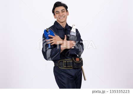 Man in blue uniform holding water bottles 135335223