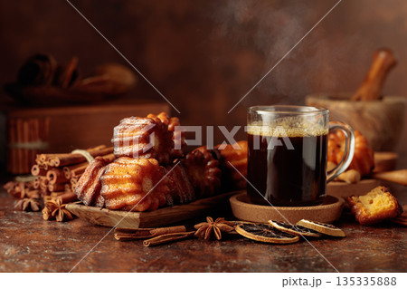 Cinnamon cakes and mug of black coffee. 135335888