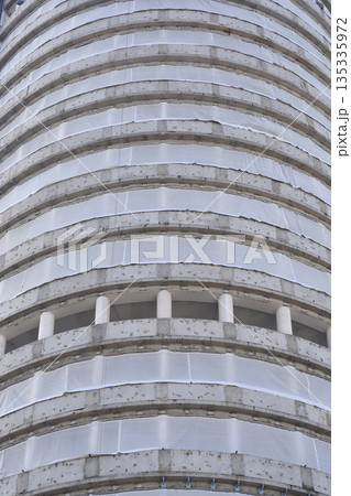 Curved concrete building under construction 135335972