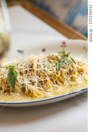 Creamy pasta with cheese and herbs on plate Creamy pasta with cheese and herbs on plate 135336431