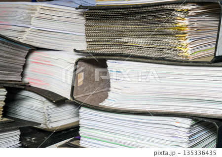Stacks of accounting document folders and paperwork files in office archive storage 135336435