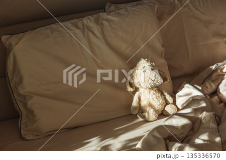 Plush Sheep Toy on Cozy Bed in Morning Sunlight 135336570