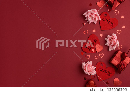 Festive Red Gift Boxes with Roses and Heart Confetti on Red Festive Background for Valentine's Day Celebration Festive Red Gift Boxes with Roses and Heart Confetti on Red Festive Background for Valentine's Day Celebration 135336596