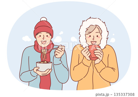 Frieds lunch standing under snow in winter clothes, trying to stay warm during december trip 135337308