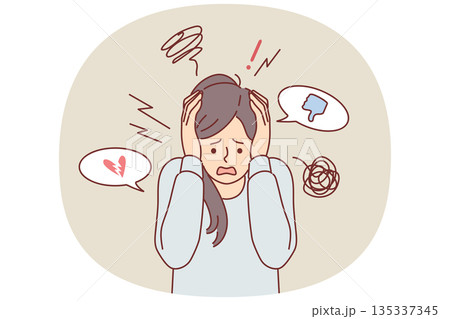 Woman suffers from digital addiction or cyberbullying and screams, clutching head 135337345