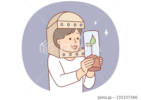 Astronaut boy holds tree in test tube and dreams of growing plants flying into space Astronaut boy holds tree in test tube and dreams of growing plants flying into space 135337366