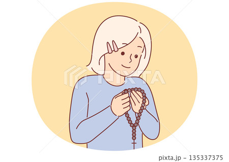 Little christian girl holding rosary with cross and praying, concept receiving religious education Little christian girl holding rosary with cross and praying, concept receiving religious education 135337375