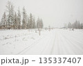 Snow Covered Rural Road During Winter Snowfall in Idaho 135337407