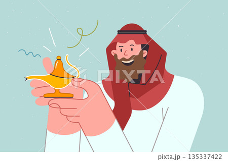 Genie in golden lamp in hands of arab man making wish, dressed in traditional dishdasha Genie in golden lamp in hands of arab man making wish, dressed in traditional dishdasha 135337422
