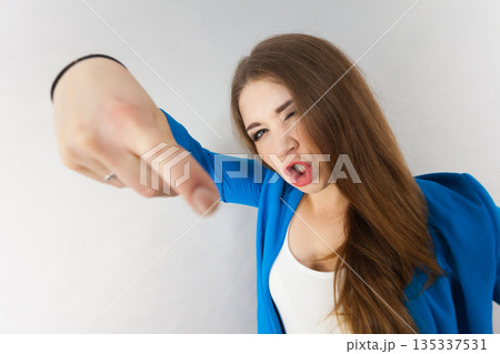 Funny woman face close up pointing 135337531