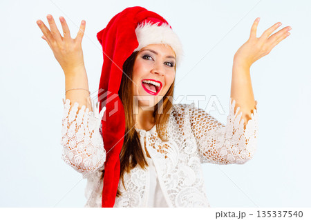 Excited woman in christmas santa hat 135337540
