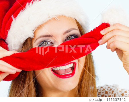 Happy woman in christmas santa hat Happy woman in christmas santa hat 135337542