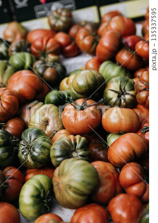 Fresh Heirloom Tomatoes At Market Stall: Red And Green Ripe Tomatoes Displayed In Abundant Traditional Food Market Scene Fresh Heirloom Tomatoes At Market Stall: Red And Green Ripe Tomatoes Displayed In Abundant Traditional Food Market Scene 135337595