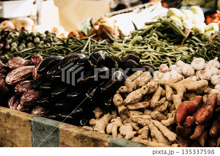 Fresh Seasonal Vegetables At Traditional Market Stall: Artichokes, Beans, Cabbage, Zuccini, Potatoes, And Root Vegetables Displayed In Abundant Mediterranean Food Market Scene Fresh Seasonal Vegetables At Traditional Market Stall: Artichokes, Beans, Cabbage, Zuccini, Potatoes, And Root Vegetables Displayed In Abundant Mediterranean Food Market Scene 135337598