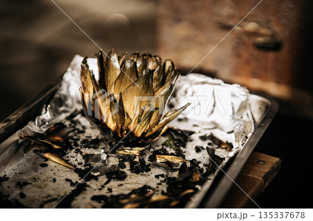 Fresh Artichokes Barbecue At Catania Market In Sicily: Trimming And Steaming Green Vegetables On Hot Surface In Traditional Street Food Scene 135337678