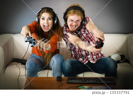 Gaming couple playing games Gaming couple playing games 135337791