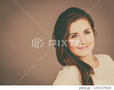 Happy positive woman with long brown hair 135337820