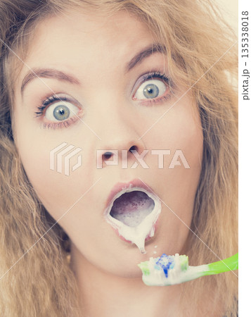 Woman brushing cleaning teeth Woman brushing cleaning teeth 135338018