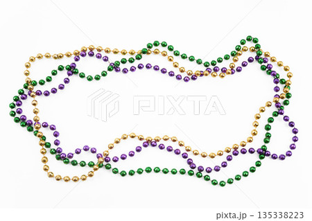 Mardi gras beads forming frame on white background 135338223