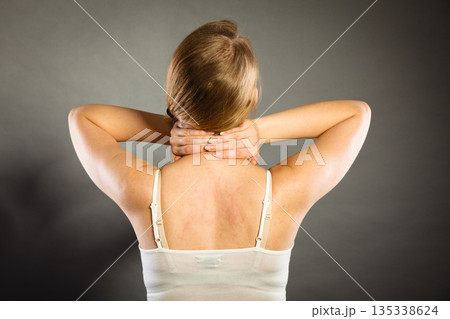 Woman suffering from neck pain 135338624