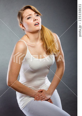 woman with hands holding her crotch woman with hands holding her crotch 135338631