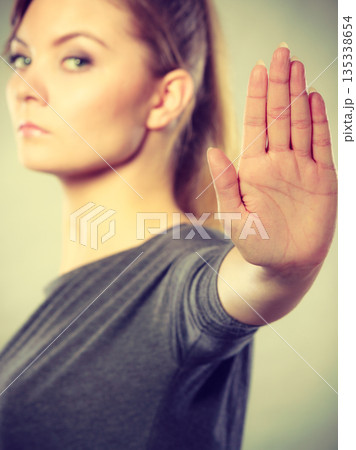 Assertive woman making stop gesture. 135338654