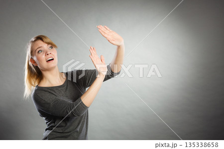 Nervous lady protecting herself. Nervous lady protecting herself. 135338658